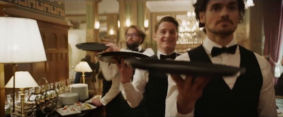 Waiters crossing the ballroom with trays