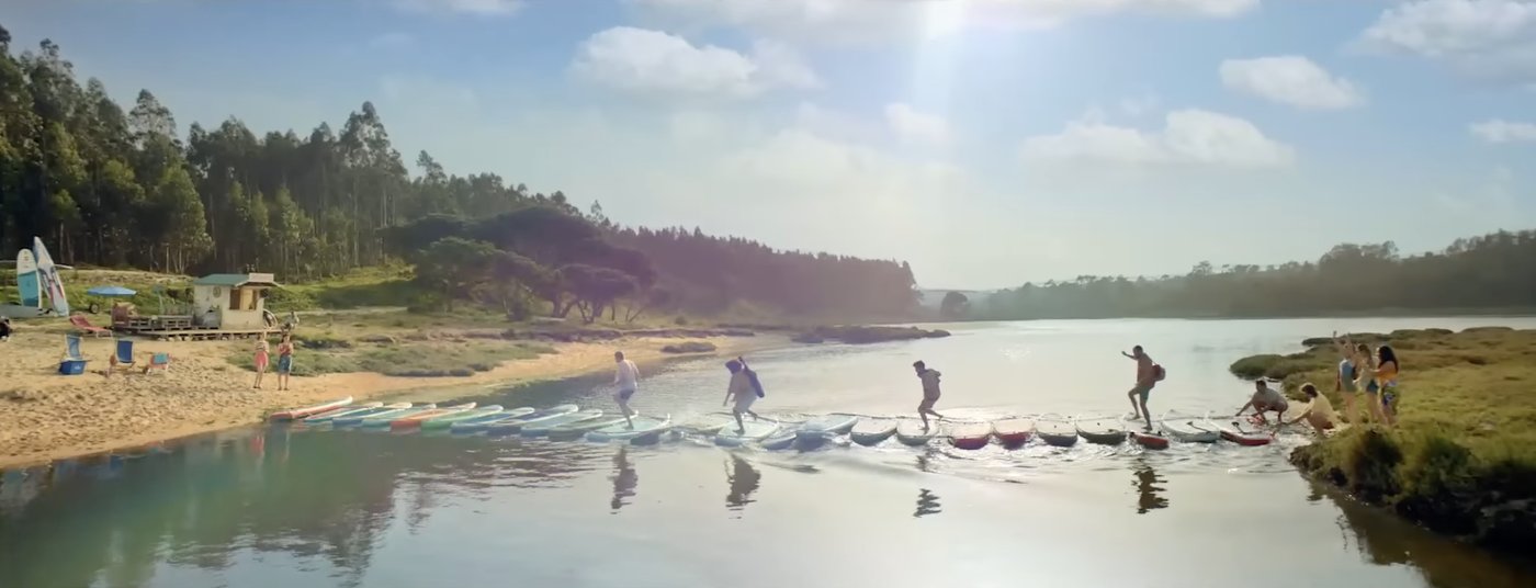 Paddleboards laid end to end as a bridge across the lake