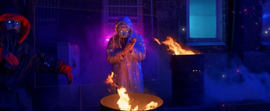 Figure at the fire barrel in blue light